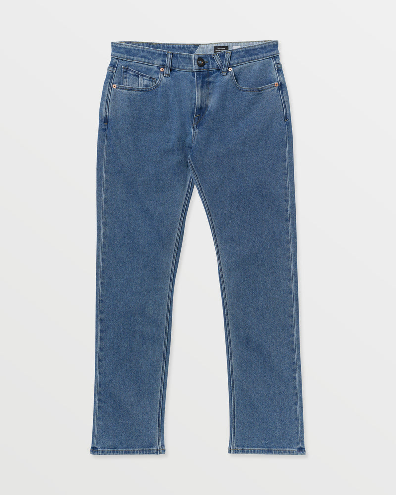 The Men's Solver Denim from Volcom Brand Jeans features a classic blue wash, straight-leg cut, five pockets, and a button closure, displayed flat on a plain white background.