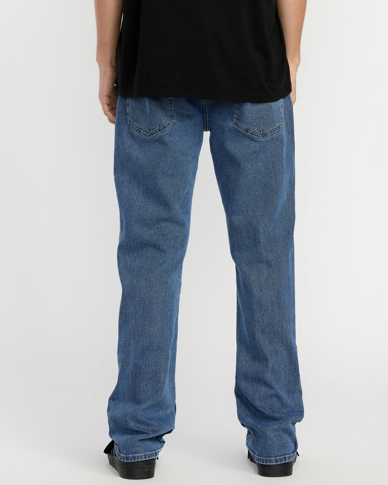 A person wearing a black shirt and Men's Solver Denim jeans stands with their back to the camera against a plain white background.