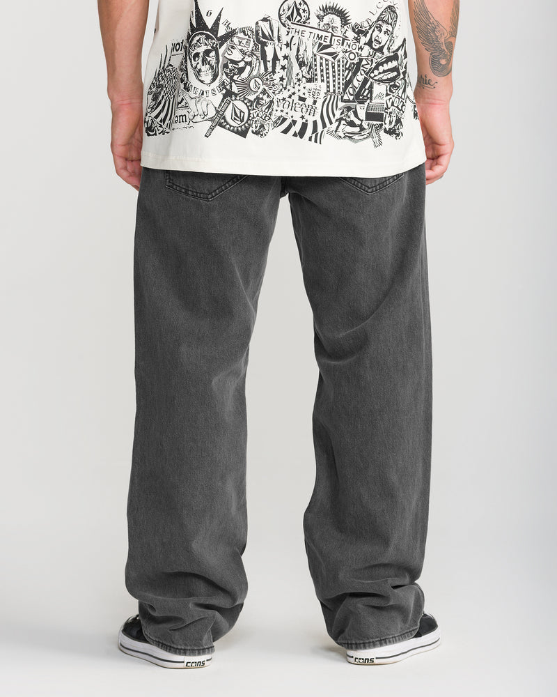 Back view of a person wearing Volcom Men’s Pipe Dreams Denim in a relaxed straight fit, paired with black sneakers.
