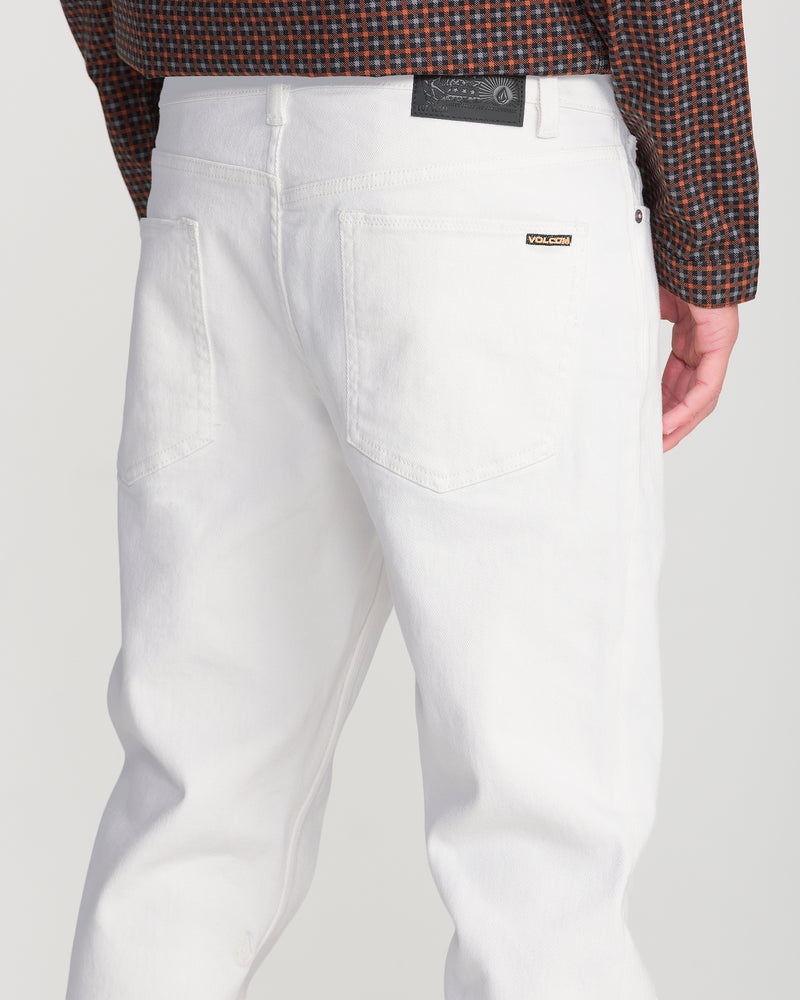 Back view of white stretch denim Men’s Solver Denim straight leg jeans, featuring two back pockets and a black leather patch on the waistband.