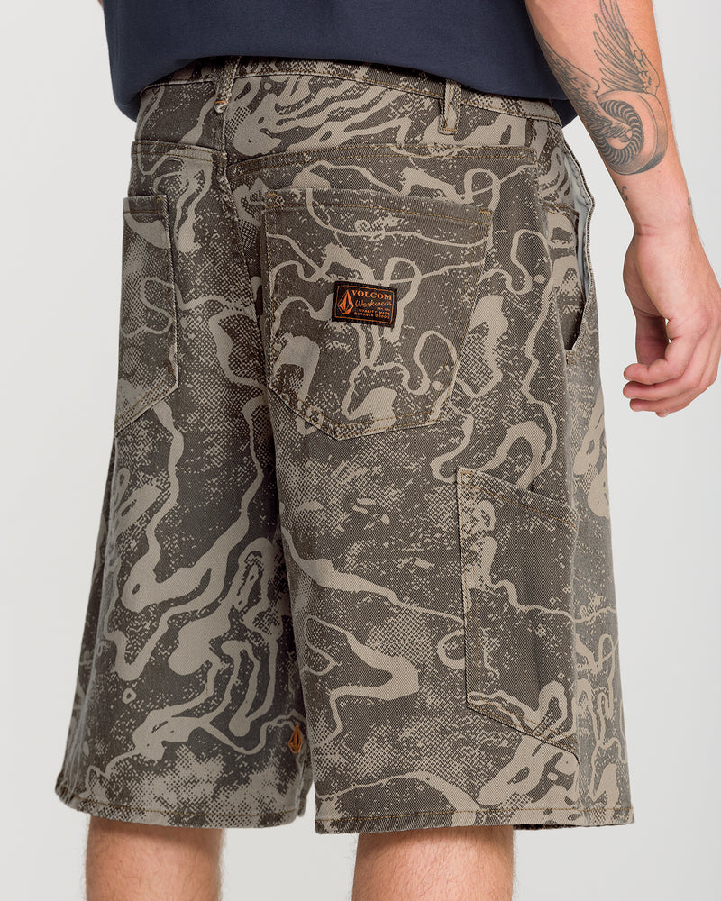 Volcom Men’s Kinkade Utility Denim Short 22 in an olive green and tan abstract camo denim pattern, featuring a knee-length fit, a logo patch on the back pocket, and a side utility pocket.