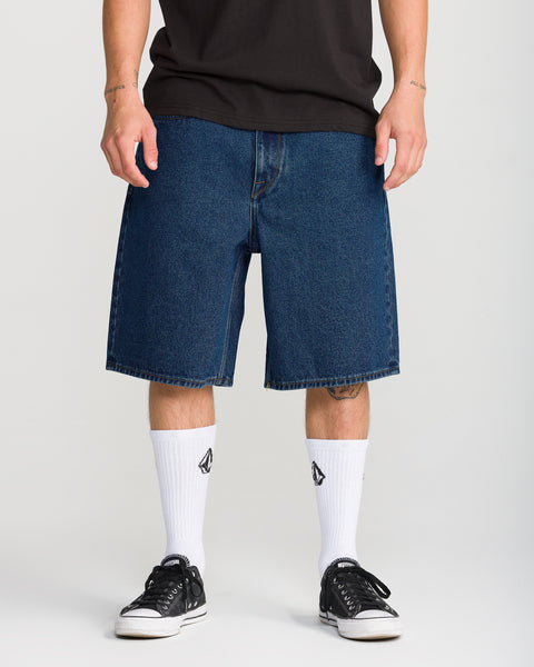 Volcom Men’s Billow Denim Short 22 in indigo, worn with a black t-shirt, white crew socks, and black sneakers.