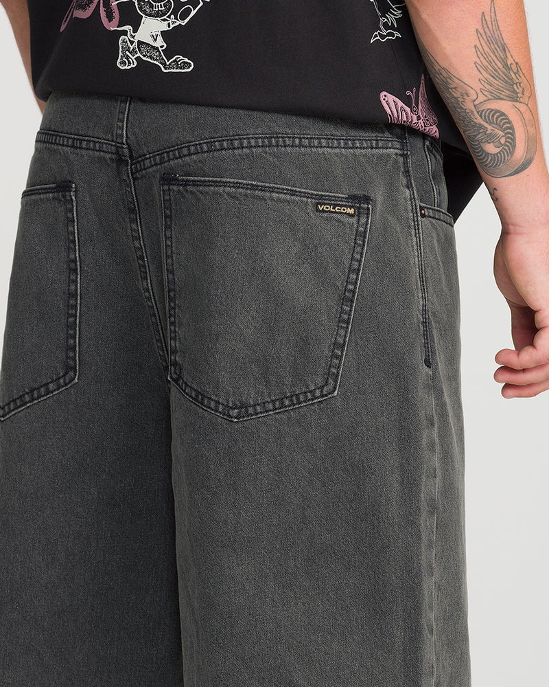 Back view of loose-fit charcoal-colored Volcom Men’s Billow Denim Short 22 with two back pockets.