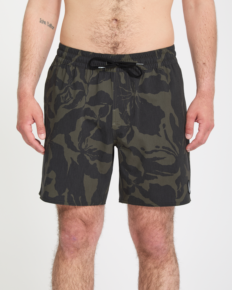 A man wearing the Volcom Men's Psyche Cotton Trunk 17 swimsuit.