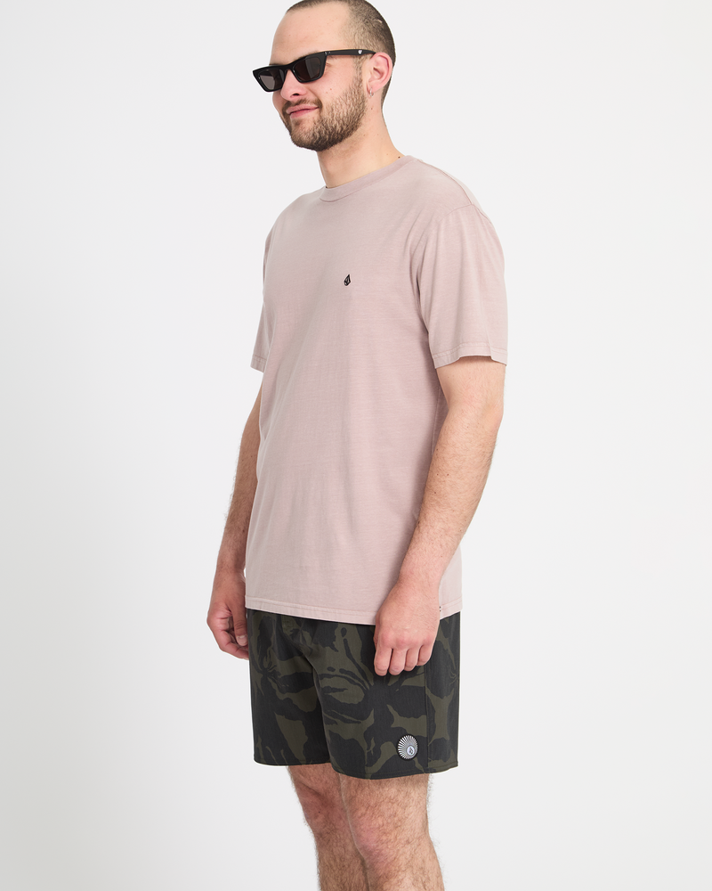 A man models the Volcom Men's Psyche Cotton Trunk 17 shorts, standing against a plain white background and facing slightly to the side with a neutral expression.