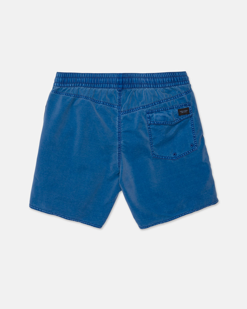 Men’s Center Elastic Waist Trunks by Volcom in blue, featuring an elastic waistband, a single back pocket on the right side with a small black rectangular label above it. The slightly textured 17-inch boardshorts are displayed flat on a white background.