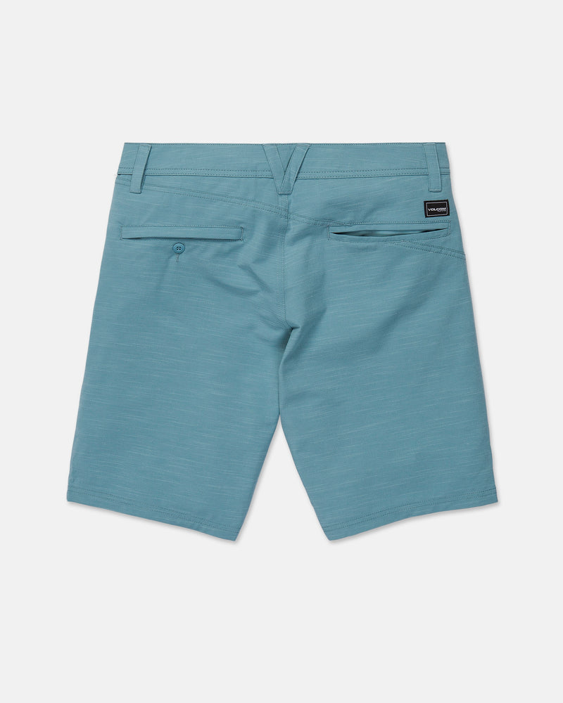 The Volcom Men's Slub Frickin Cross Shred Hybrid Shorts are displayed from the back in light blue, showcasing two rear pockets—one secured with a button—and a small black Volcom label above the right pocket. Designed with a modern fit, these hybrid shorts feature belt loops and a sleek, clean look.