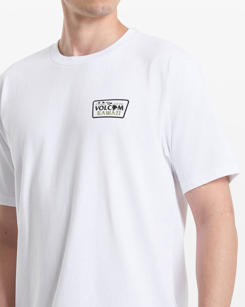 A person wearing the Volcom Men's Dispatch Short Sleeve Tee, featuring a small rectangular Volcom Hawaii logo on the left chest. The photo shows the upper torso and part of the left arm against a white background.
