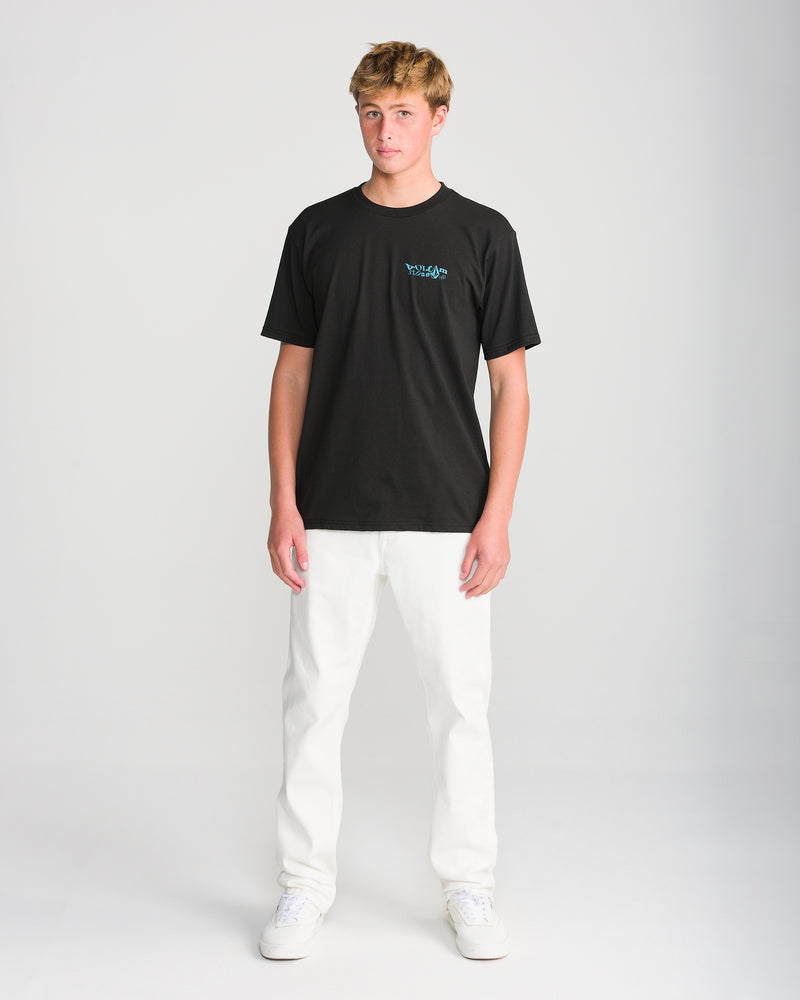 A person wearing a Volcom Men’s Framer Short Sleeve Tee with a blue graphic on the chest, paired with white pants and white sneakers for daily wear.