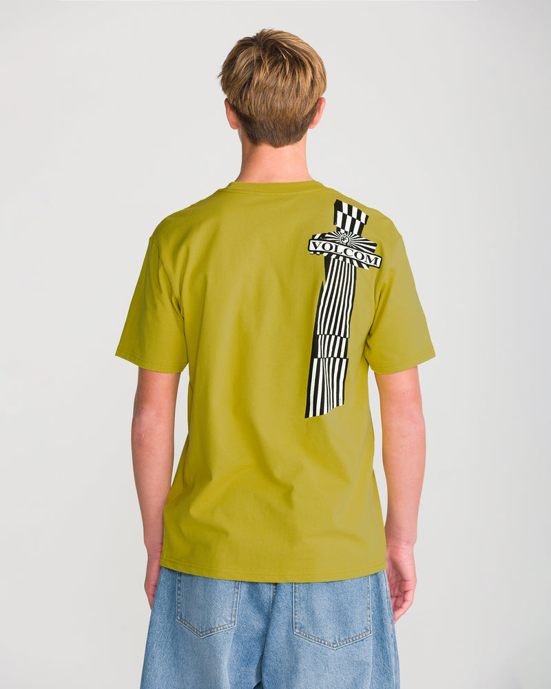 A person wearing the Men’s Opposition Short Sleeve Tee by Volcom—a light green, tagless T-shirt with a black and white striped VOLCOM graphic on the back—paired with light blue denim shorts.