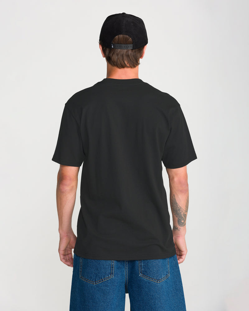 Back view of a person wearing a black Men’s Remastered Stone Short Sleeve Tee, a black baseball cap, and blue jeans.