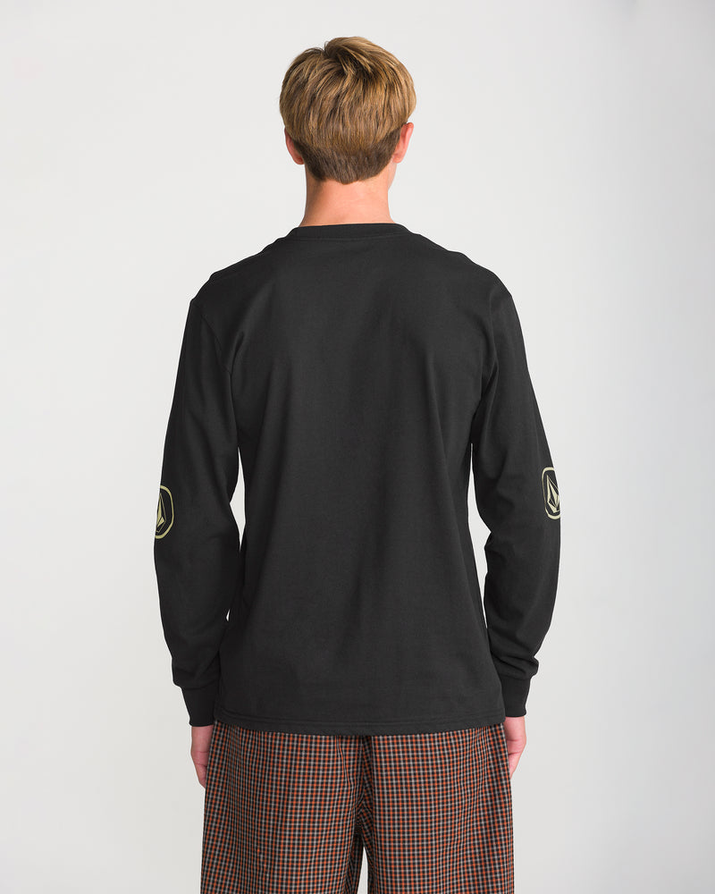 Back view of a person wearing a black Volcom Men’s Remastered Stone Long Sleeve Tee, featuring a classic fit, heavyweight fabric, and a small emblem on each elbow.