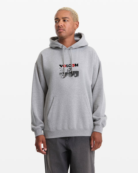 A man wears the Volcom Men's Featured Artist Seth Conboy Pullover, a light gray hoodie with a front pocket and red VOLCOM graphic on the chest, standing against a plain white background.