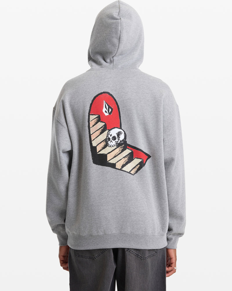 A person faces away from the camera in the Volcom Men's Featured Artist Seth Conboy Pullover, a gray hoodie with the hood up and a graphic on the back featuring stairs, a skull at the bottom, and a red background.