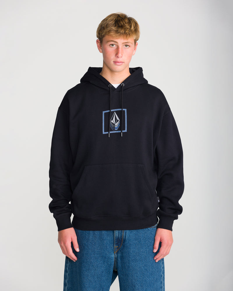 A young person with short blond hair wears the Volcom Men’s Quadratic Pullover and blue jeans, standing against a plain light background.