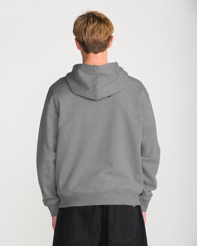 A person faces away from the camera, wearing the Volcom Men’s Quadratic Pullover in gray brushed-back fleece with dark pants, set against a plain white background.