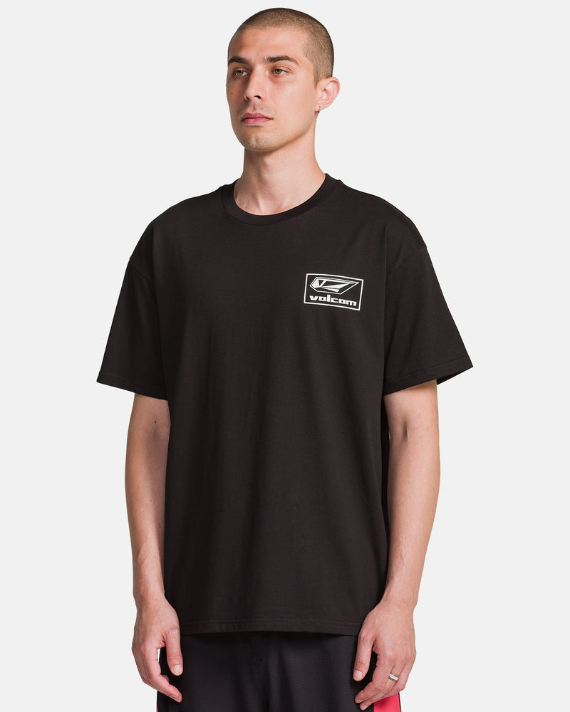 A man models the Volcom Men's Surf Vitals Modstone Short Sleeve Tee, a loose fit made from premium ringspun cotton with a small white logo on the left chest, standing against a plain white background.