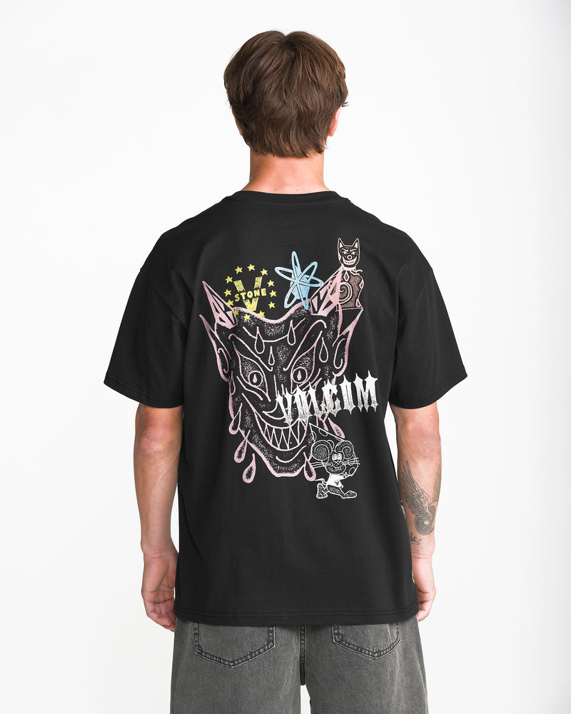 Seen from behind, a person wears a black Men’s Featured Artist Casey Jones Short Sleeve Tee featuring a heavyweight premium cotton construction with a graphic of a stylized, cartoonish horned character and abstract symbols.