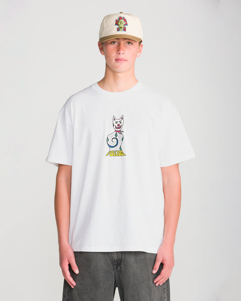 A person wears a white Volcom Men’s Featured Artist Casey Jones Short Sleeve Tee featuring a stylized cat graphic and a baseball cap with a colorful dragon design by a Brooklyn illustrator.