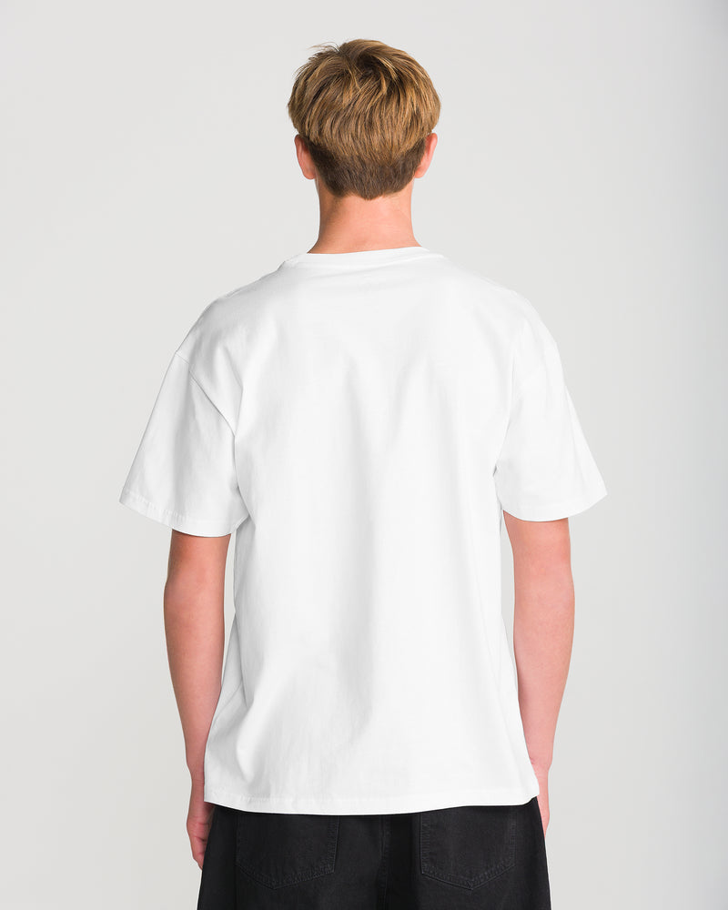 Back view of a person wearing a heavyweight, loose-fit white Men’s Hand Held Short Sleeve Tee and black pants.