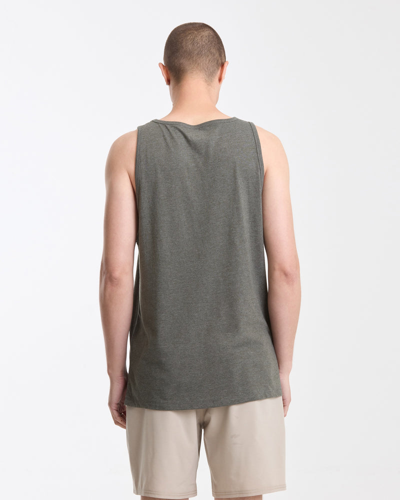 A man with short hair stands with his back to the camera, wearing a Volcom Men's Solid Heather Tank and light beige shorts against a plain white background.