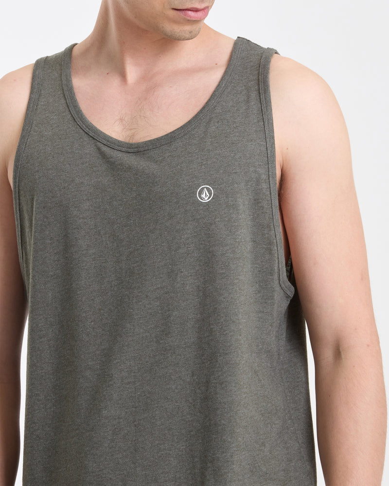 A man is shown from shoulders to waist, wearing the Volcom Men's Solid Heather Tank— a sleeveless, gray heather fitted top with a small white circular logo on the chest, facing slightly to the side.