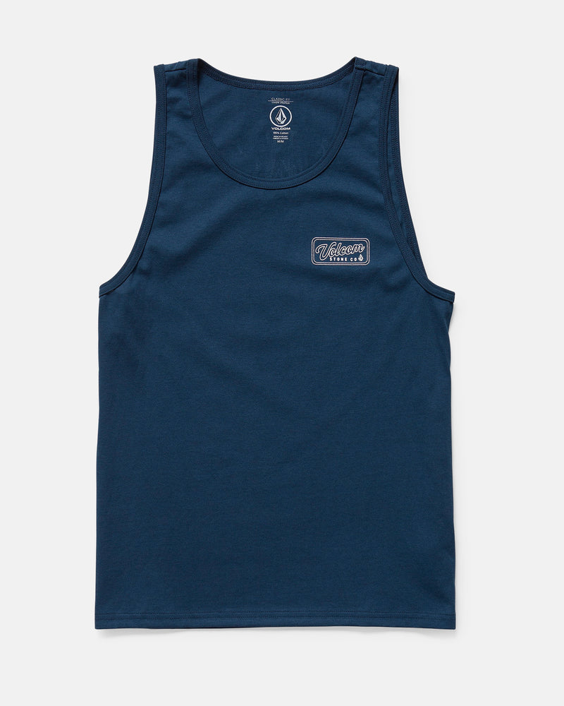 The Volcom Men's Wrecking Tank is a navy blue, sleeveless, classic-fit shirt made of 100% cotton. It has a small rectangular patch with white and blue text on the left chest and is shown laid flat on a white background.