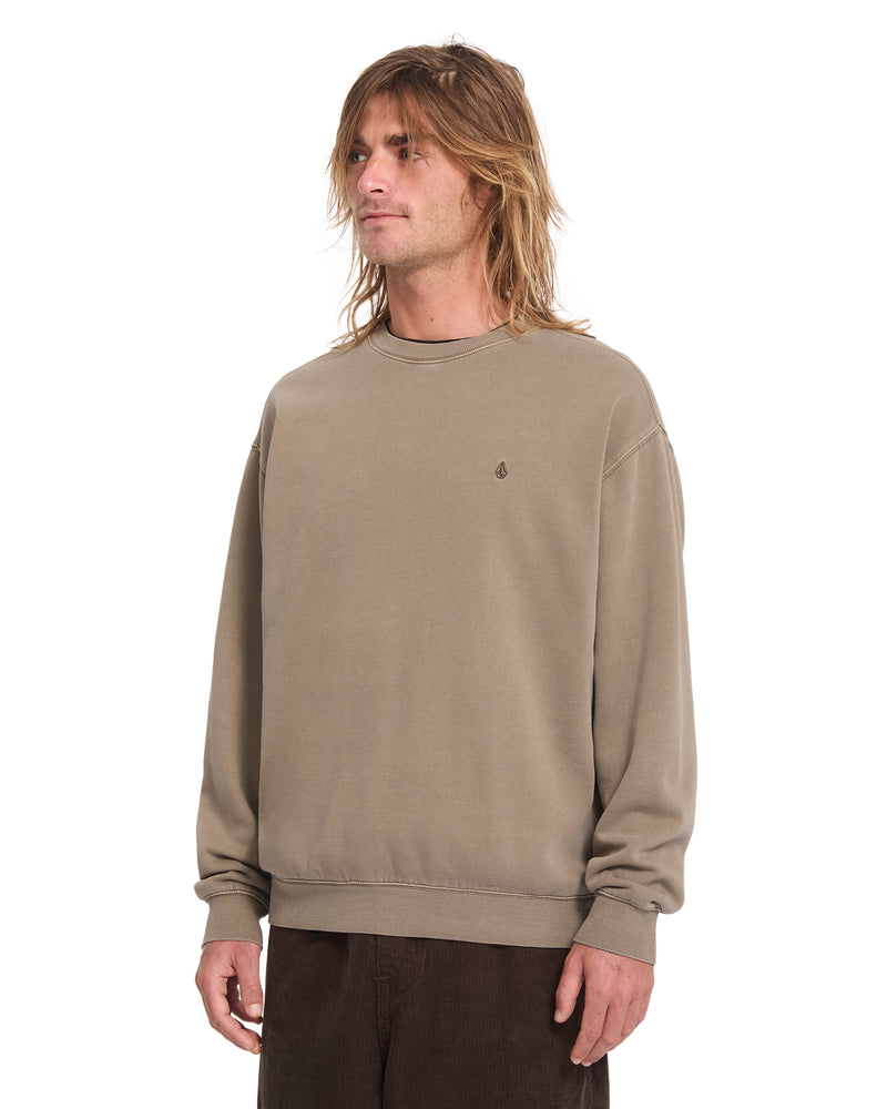 A person wearing a tan heavyweight cotton-blend Volcom Men’s Single Stone Power Wash Crew fleece sweatshirt with an embroidered Stone logo on the left chest.