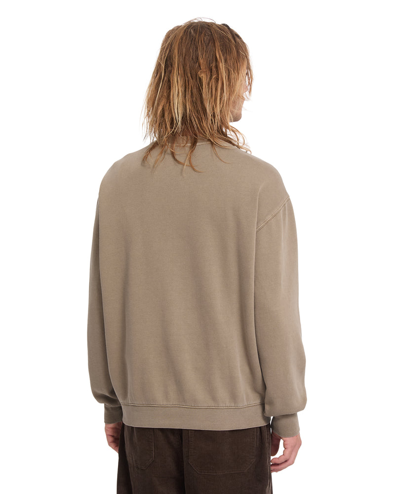 A person viewed from behind wearing a tan classic fit Volcom Men’s Single Stone Power Wash Crew.