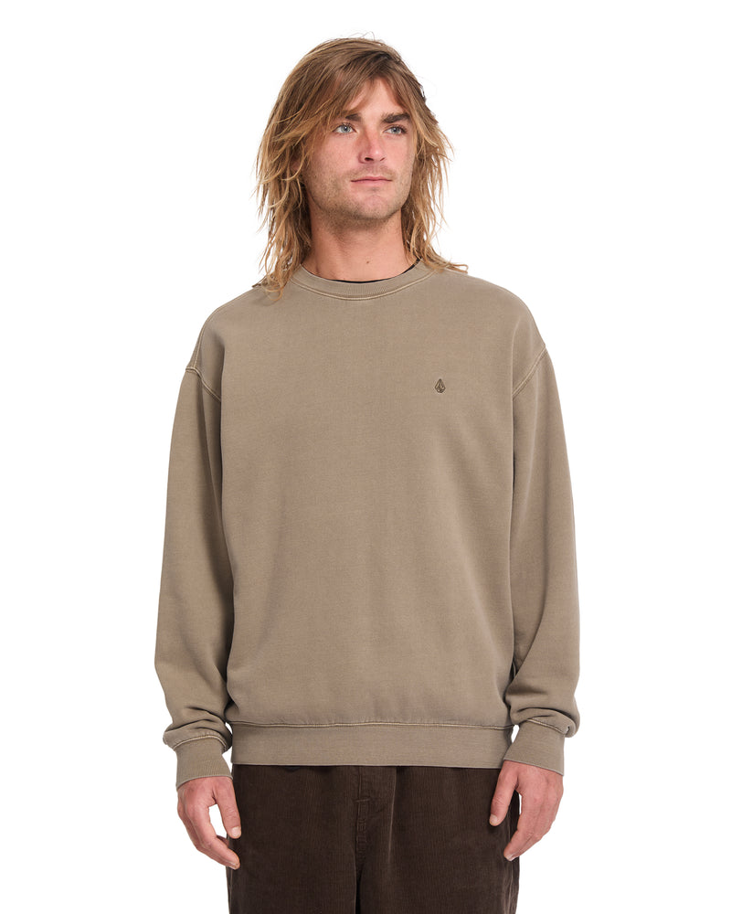 A person wears a tan, classic fit Men’s Single Stone Power Wash Crew with a crew neck and embroidered Stone branding on the left chest.