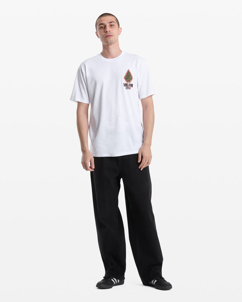 A person stands against a white background, wearing the Volcom Men's Mindsign Short Sleeve Tee with a small chest logo, paired with black pants and black sneakers with white stripes—an ideal choice for effortless everyday wear.