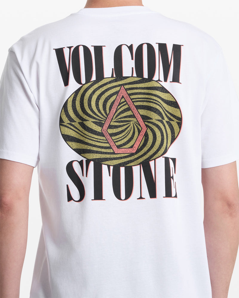 A person wears the Volcom Men's Mindsign Short Sleeve Tee, an all-cotton shirt with VOLCOM STONE in bold black letters and a swirling green and black oval on the back with a red diamond logo—ideal for everyday style.