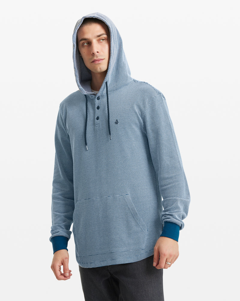 A person wearing the Volcom Men's Murph Thermal Long Sleeve in light blue and black pants stands against a plain white background.