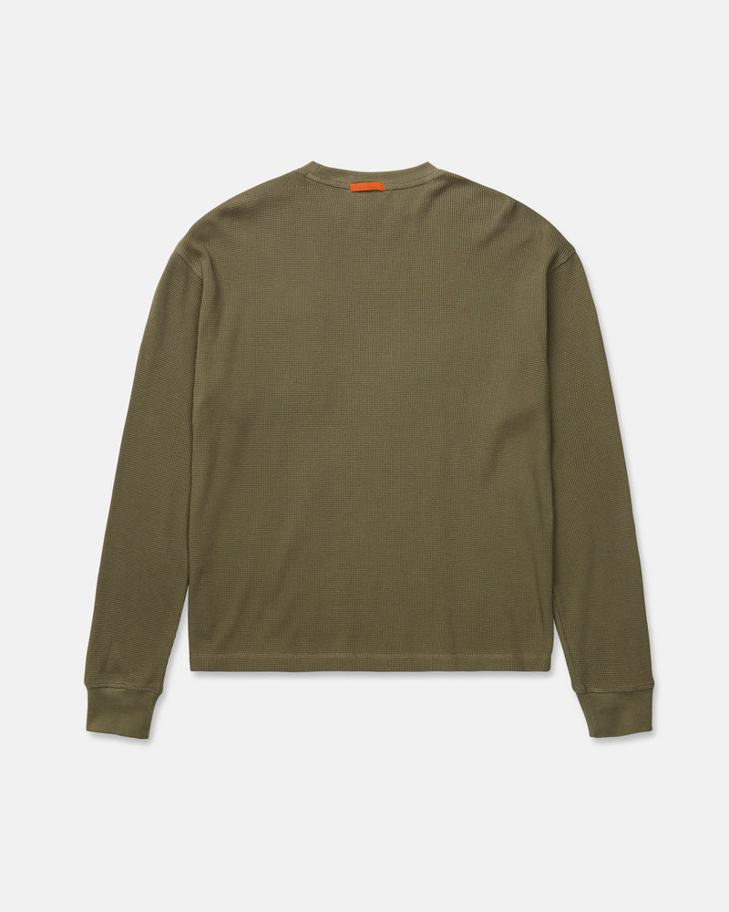 Volcom Men's Overtime Workwear Thermal Long Sleeve Shirt in olive green, shown from the back, features ribbed cuffs and a small orange tag near the collar. Made from soft cotton knit fabric, this thermal shirt delivers comfort and durability for demanding workwear needs.