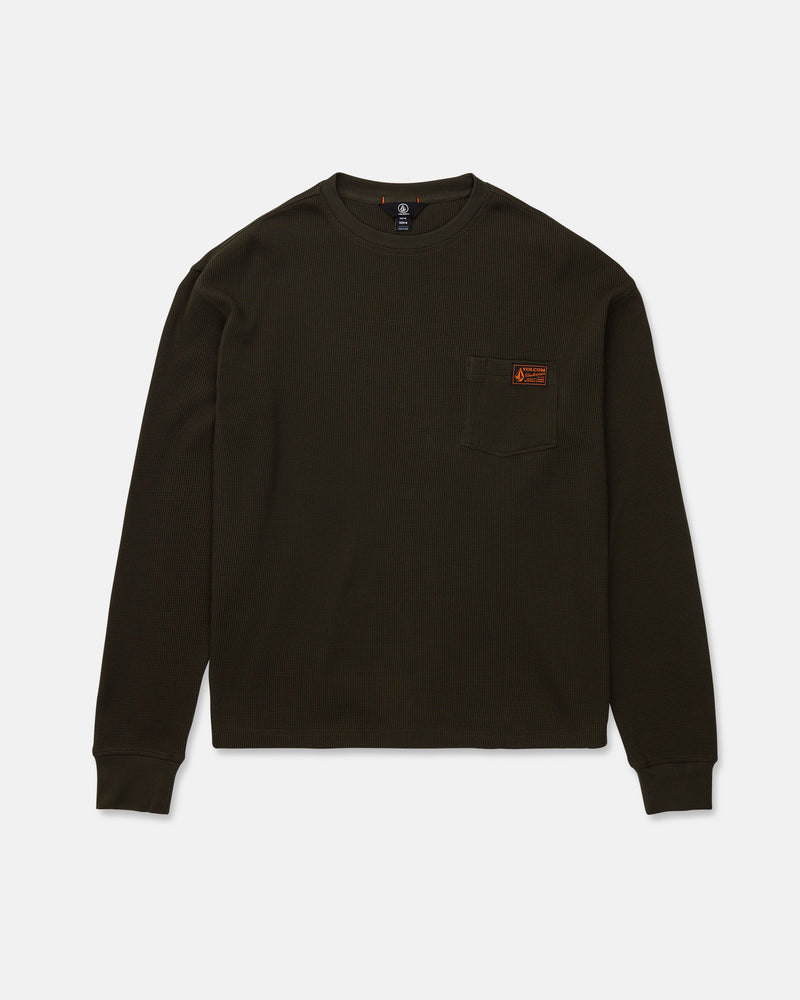 The Volcom Men's Overtime Workwear Thermal Long Sleeve Shirt is shown laid flat on a white background. This dark green, ribbed shirt features classic workwear styling with long sleeves, a crew neckline, and a small chest pocket adorned with a brown rectangular patch.