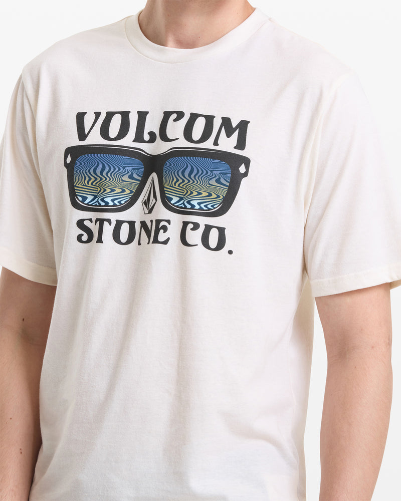 A person wears the Volcom Men's Sunnies Short Sleeve Tee, featuring “VOLCOM STONE CO.” printed above and below sunglasses with a wavy blue and green reflection. The person’s face is not visible.
