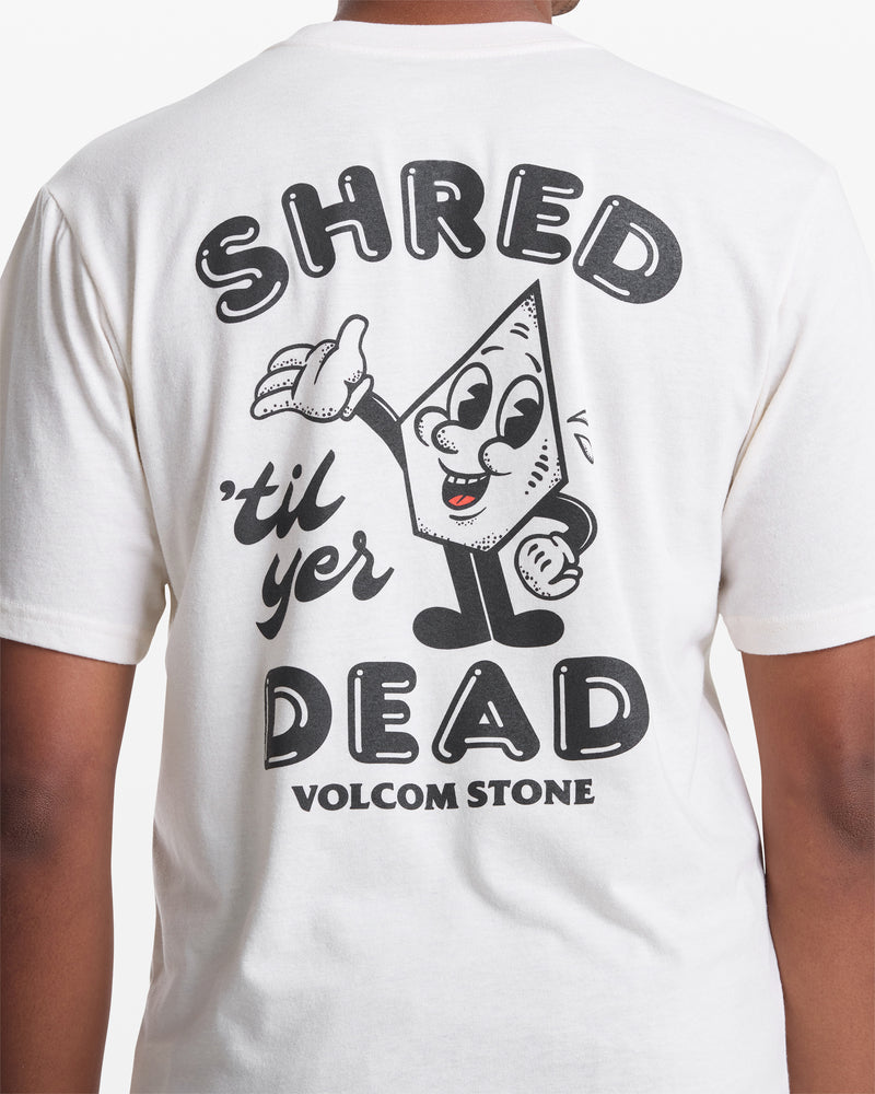 A person wears the Volcom Men's Mister Stone Short Sleeve Tee, featuring a cartoon stone character and “SHRED til yer DEAD” with bold “VOLCOM STONE” lettering on the back.