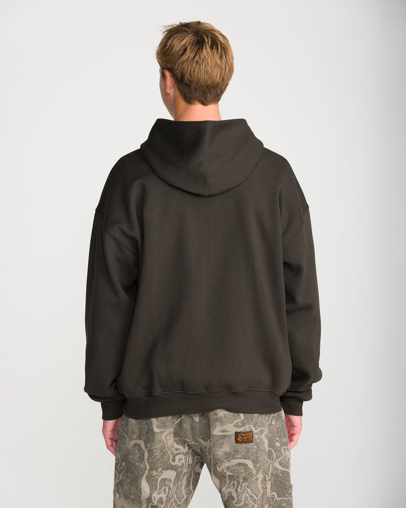 A person seen from behind wears a Volcom Men’s Driggs Workwear Zip brushed-back fleece dark brown hooded sweatshirt and camouflage workwear pants with a rectangular patch on the back pocket.