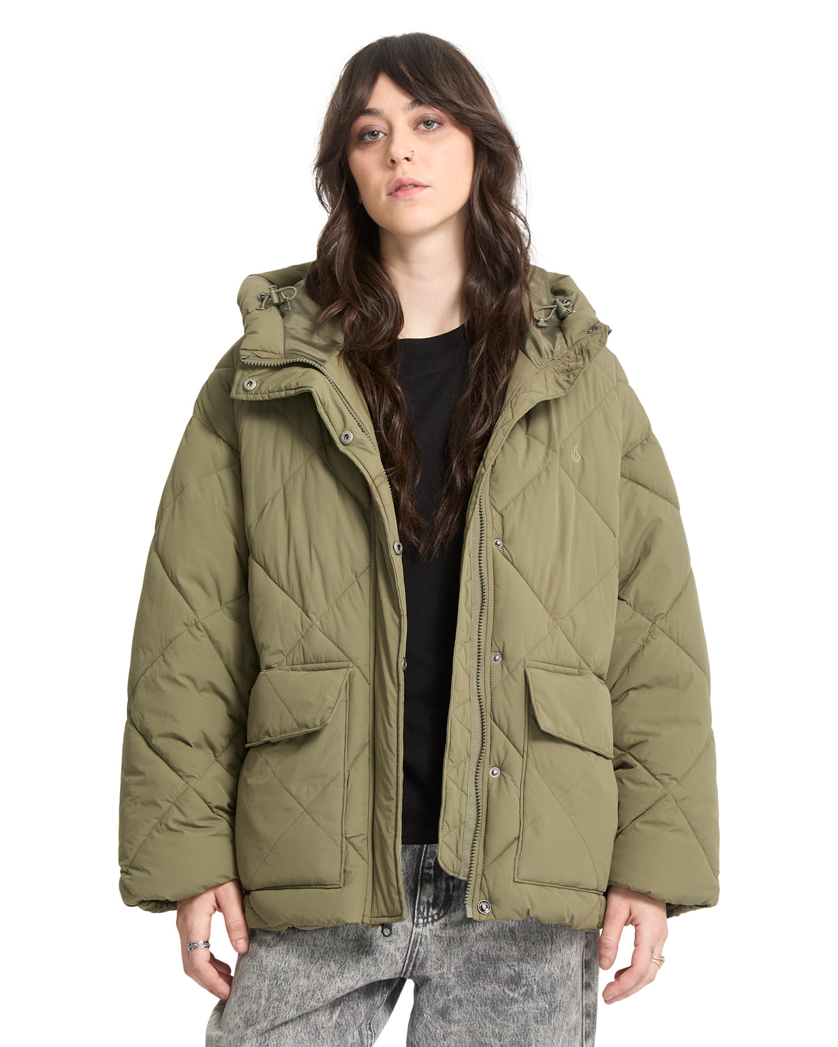 A person wears an olive green, cropped heavyweight Volcom Out Of Boxy Puff jacket featuring a hooded design, two front pockets, and a snap-button closure.