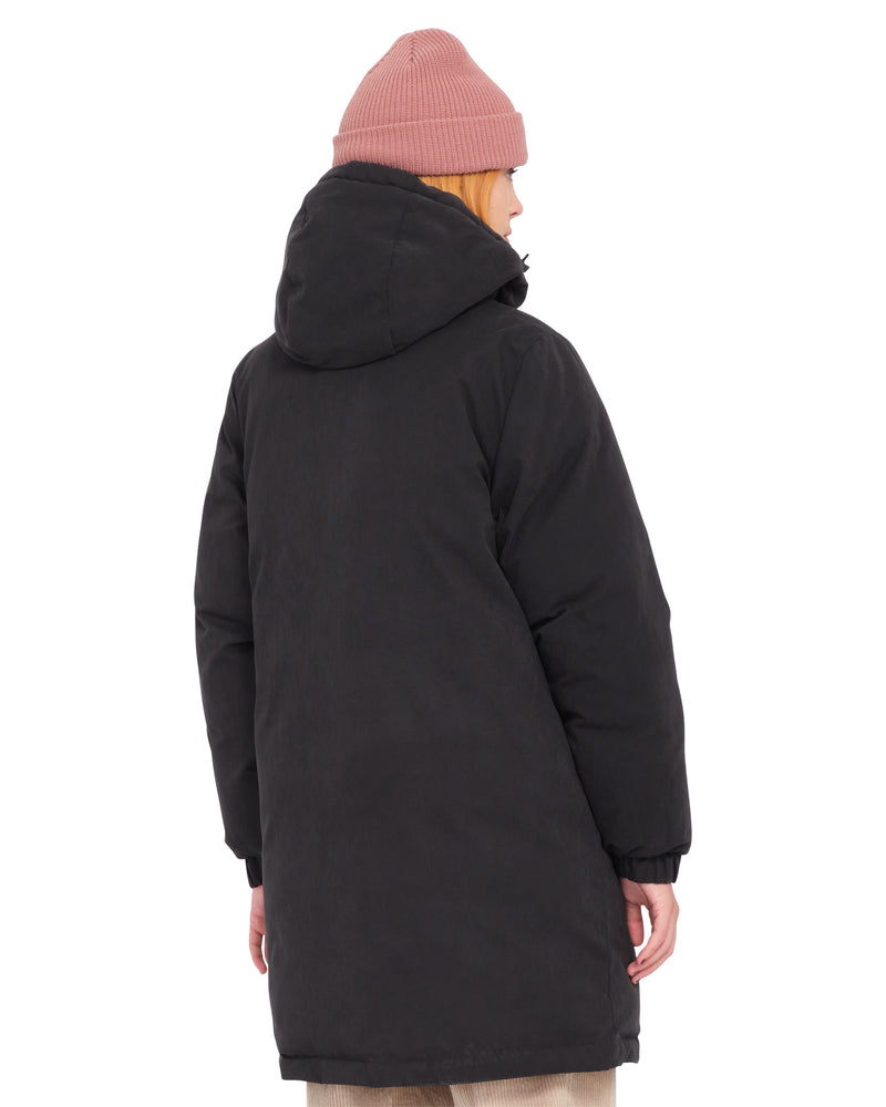 A person seen from the back wearing a Volcom Women’s Sleepi Puff Up Parka and a pink beanie.