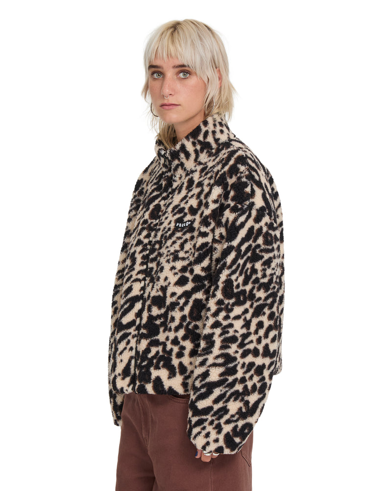 A person wearing a Volcom Wylding Out Sherpa, an oversized leopard-print jacket with a high collar and a zip-up front.