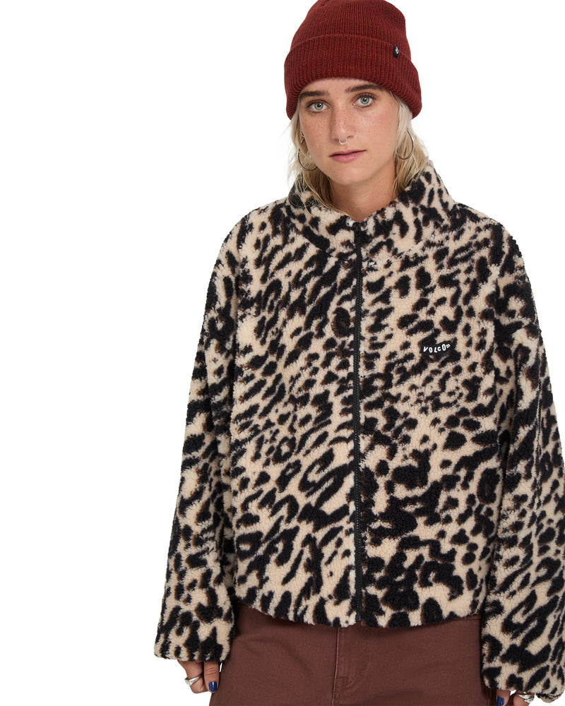 A person wearing a Volcom Wylding Out Sherpa jacket in an oversized leopard print and a maroon beanie.