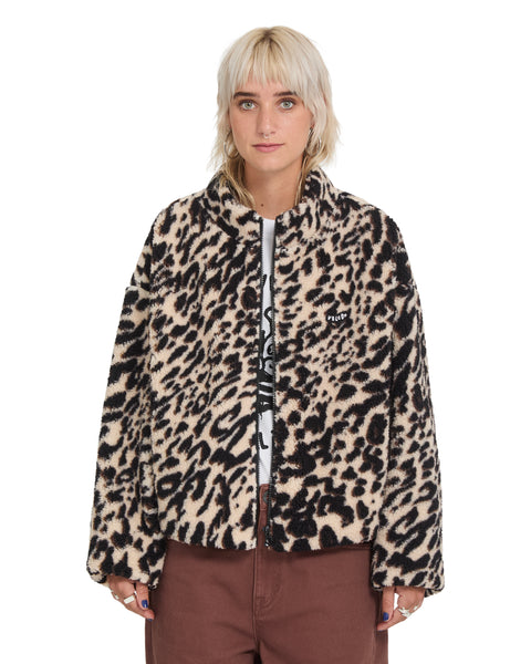 A person wears a Volcom Wylding Out Sherpa, an oversized, zip-up jacket featuring a tan and black leopard print pattern.