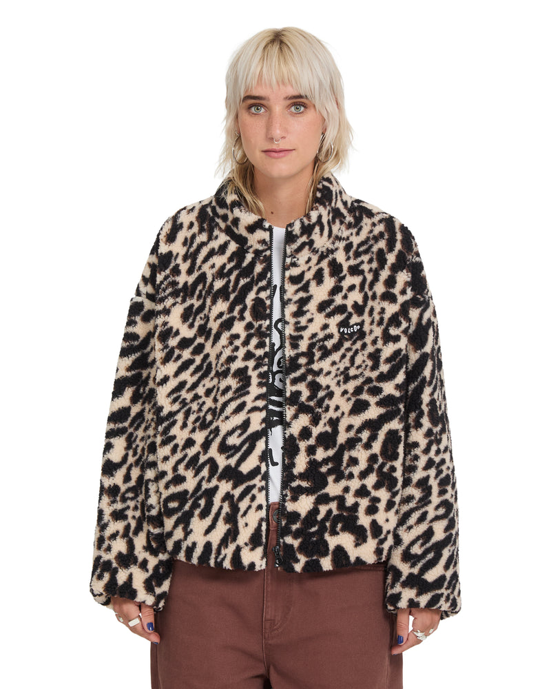 A person wears a Volcom Wylding Out Sherpa, an oversized, zip-up jacket featuring a tan and black leopard print pattern.