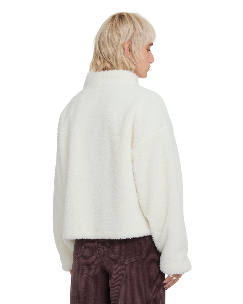 A person seen from behind wearing an oversized, off-white Volcom Women’s Wylding Out Sherpa jacket with a high collar.
