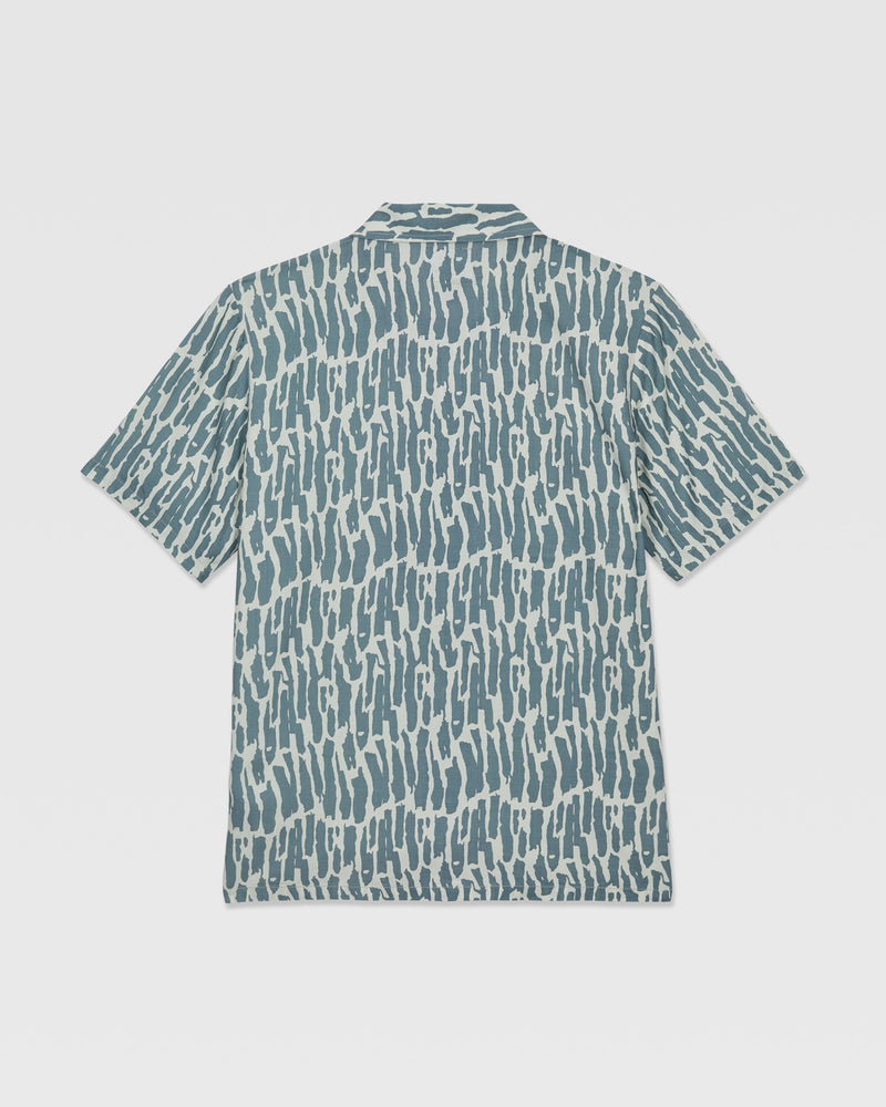 The Volcom Kids' Boldstone Short Sleeve Tee features a blue and white abstract brushstroke pattern, shown flat from the back.