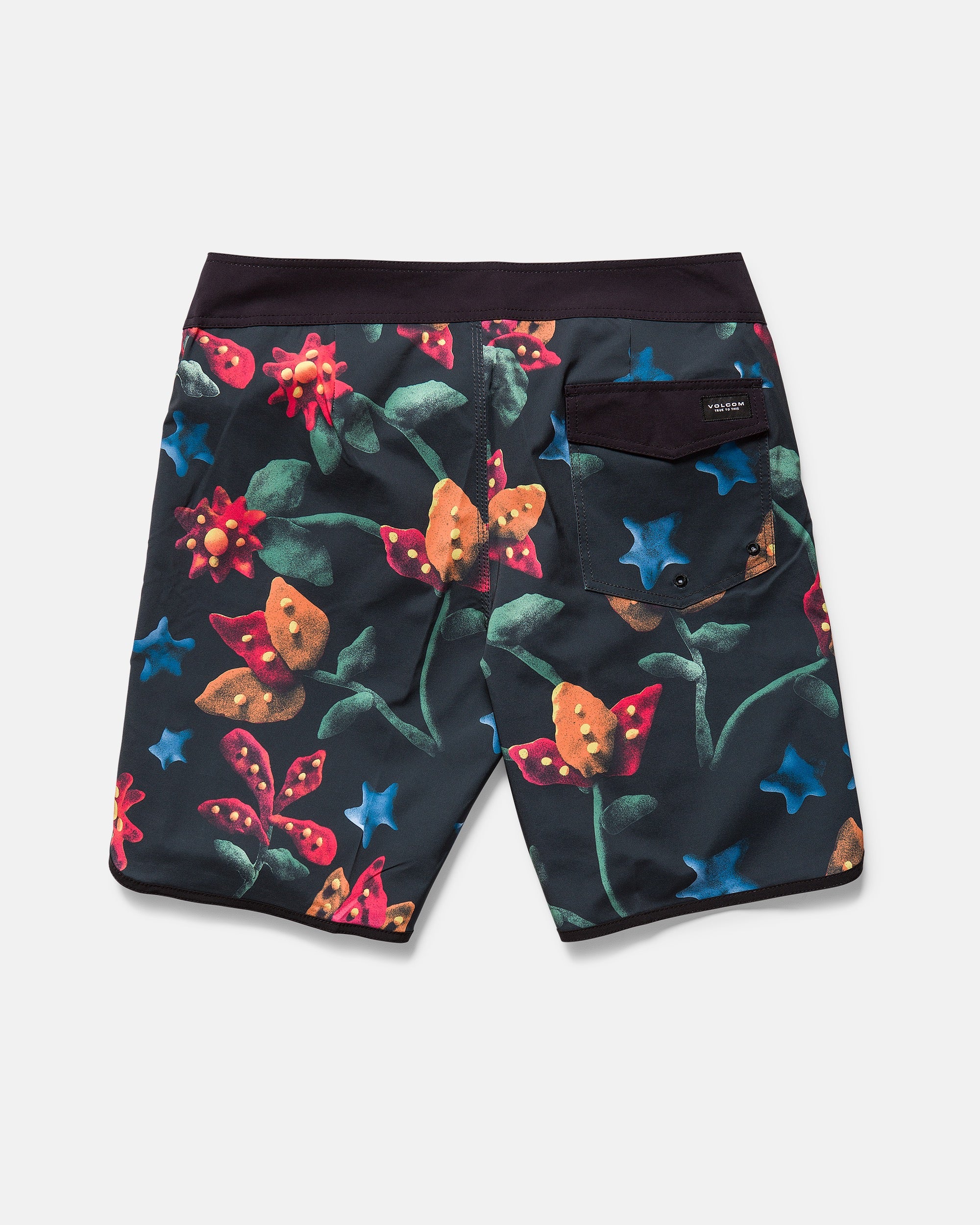 A pair of Volcom Kids' Big Boys' Infuse Scallop Mod boardshorts in dark colors, featuring a colorful botanical print with red, yellow, and blue flowers, green leaves, black waistband, Cinch Fly Technology, and a black back pocket.