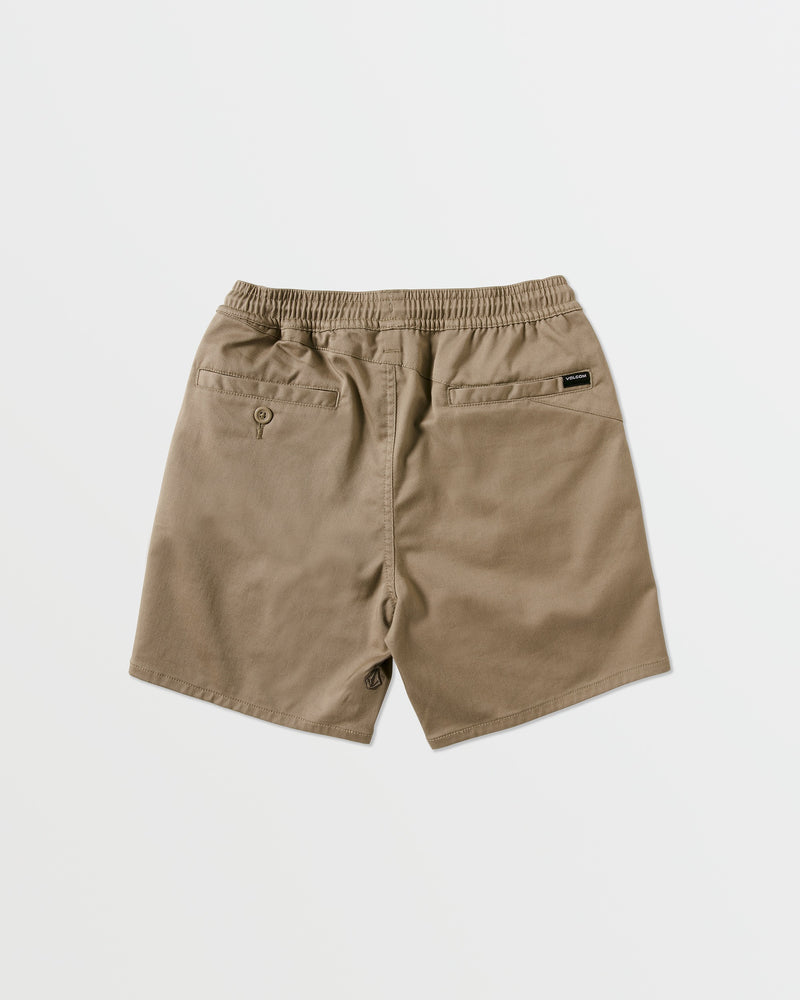 Kids' Big Boys' Frickin Elastic Waist Shorts by Volcom, in khaki recycled poly-cotton with an elastic waistband, two back welt pockets (one with a button), and a black Volcom tag on the right pocket, shown on a white background.