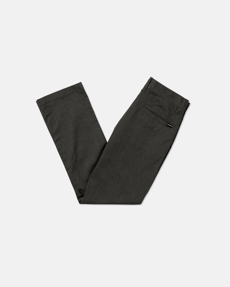 A pair of Volcom Kids' Big Boys' Frickin Modern Stretch Pants in dark gray, neatly folded in half, is displayed on a plain white background.