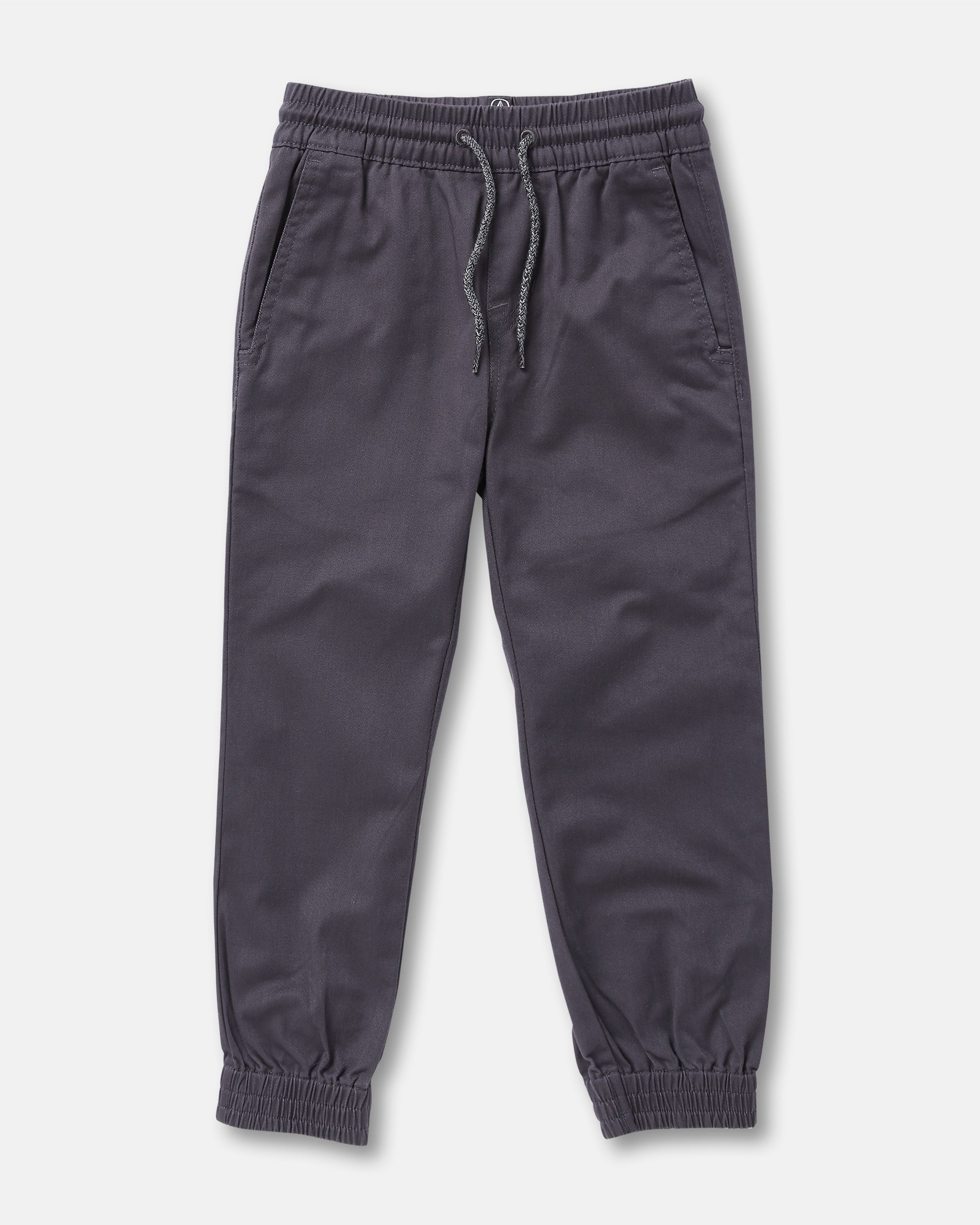 The Volcom Kids' Big Boys Frickin Slim Joggers in dark gray, made with recycled fibers, feature an elastic waist with drawstring, two side pockets, and elastic ankle cuffs; pants shown laid flat on a white background.
